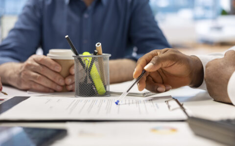 Senior people reading retirement plan contract terms with broker